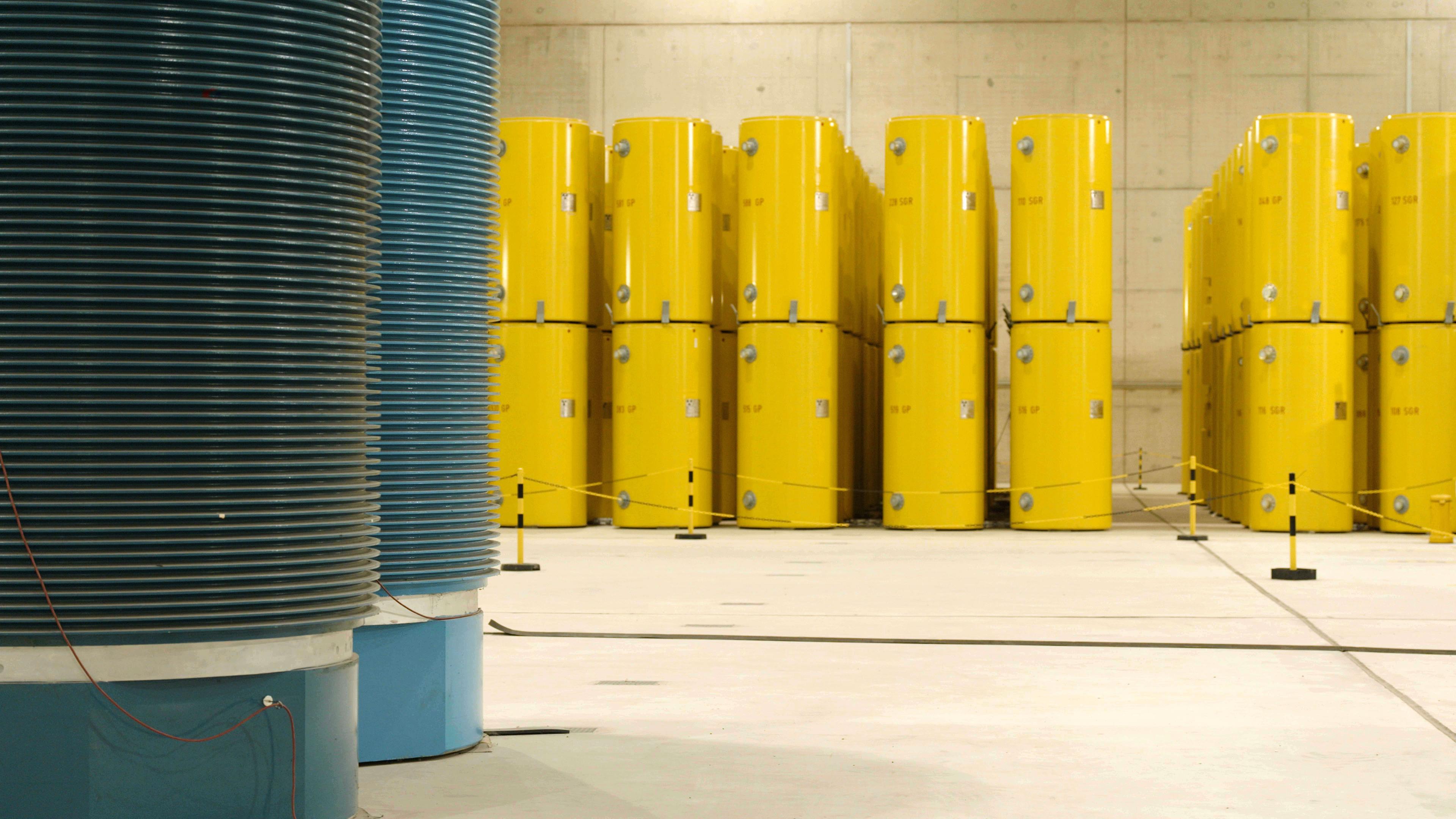 In einer Halle stehen gelbe Castorbehälter für Atommüll.