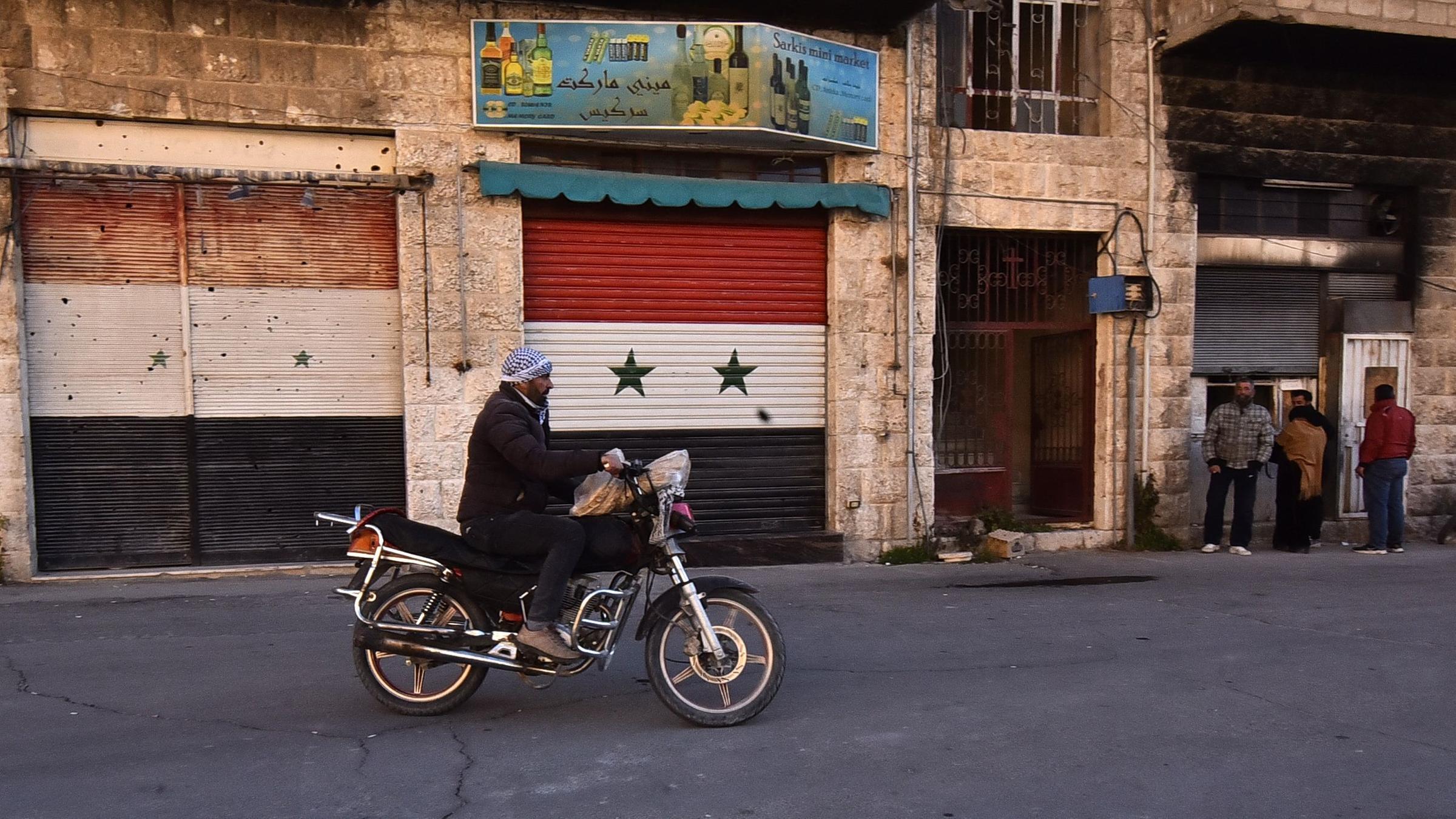 A Syrian man rides his motorcycle in the village of Maalula north of the Syrian capital Damascus