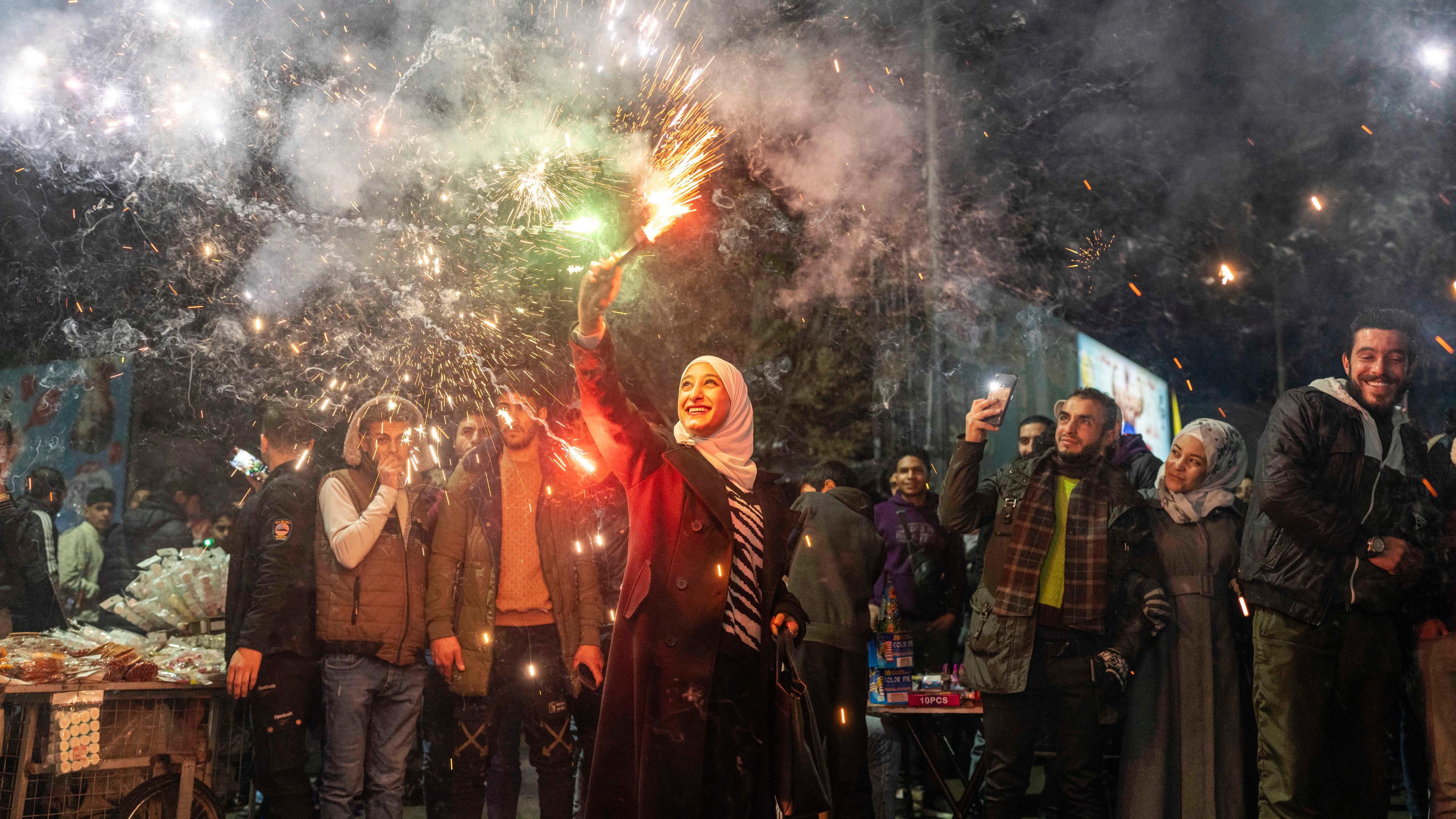 Syrians celebrate the new year after the ousting of Assad regime, in Damascus, Syria, Tuesday, Dec. 31, 2024.