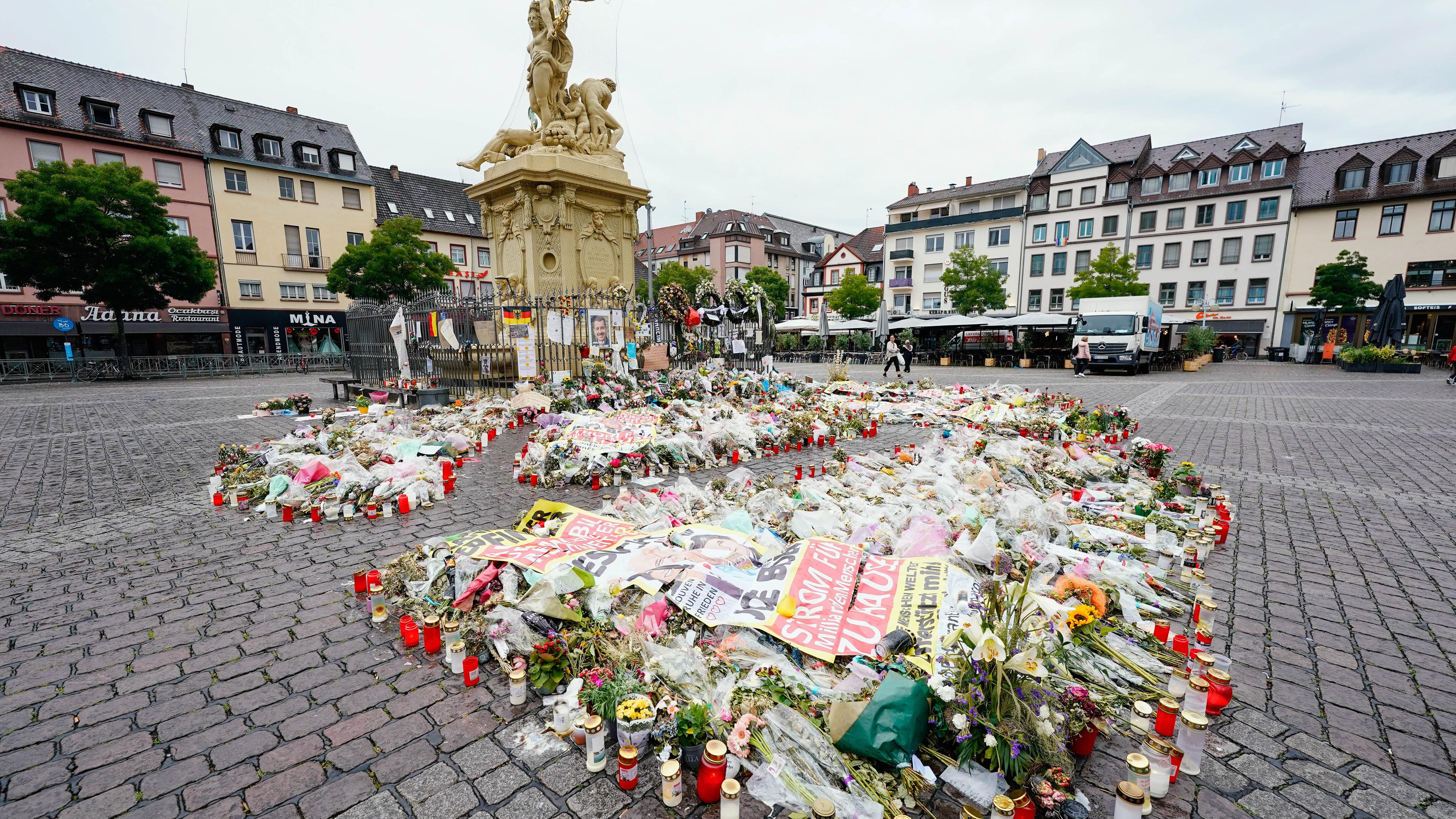 Baden-Württemberg, Mannheim: Kerzen und Blumen liegen am Maktplatz an der Trauerstelle für den getöteten Polizisten.