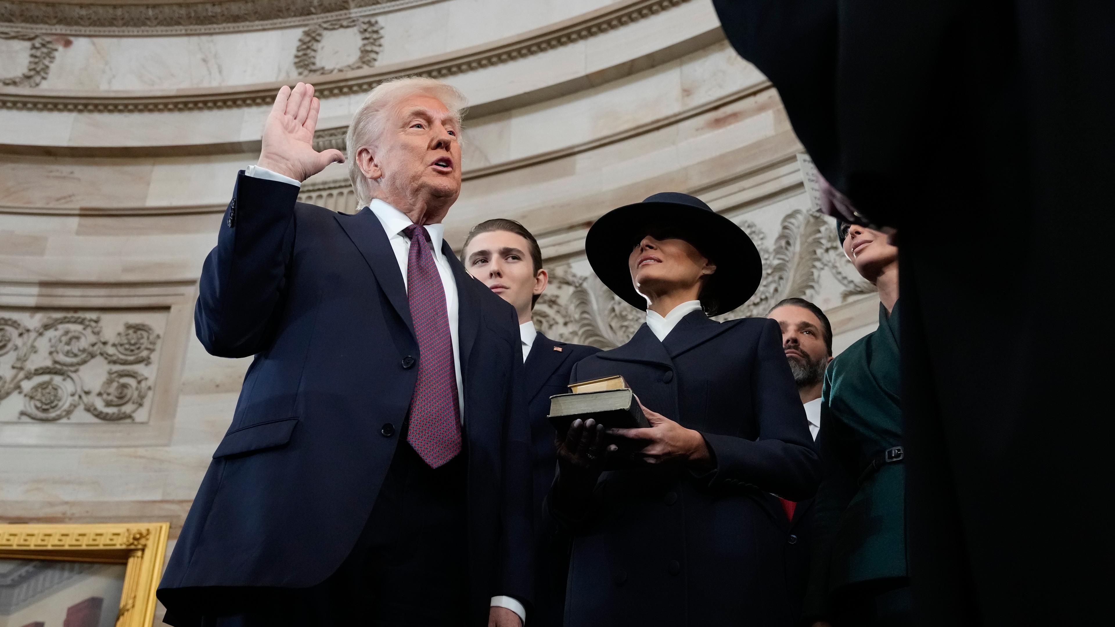 Donald Trump is sworn in as the 47th president of the United States by Chief Justice John Roberts as Melania Trump holds the Bible during the 60th Presidential Inauguration in the Rotunda of the U.S. Capitol in Washington