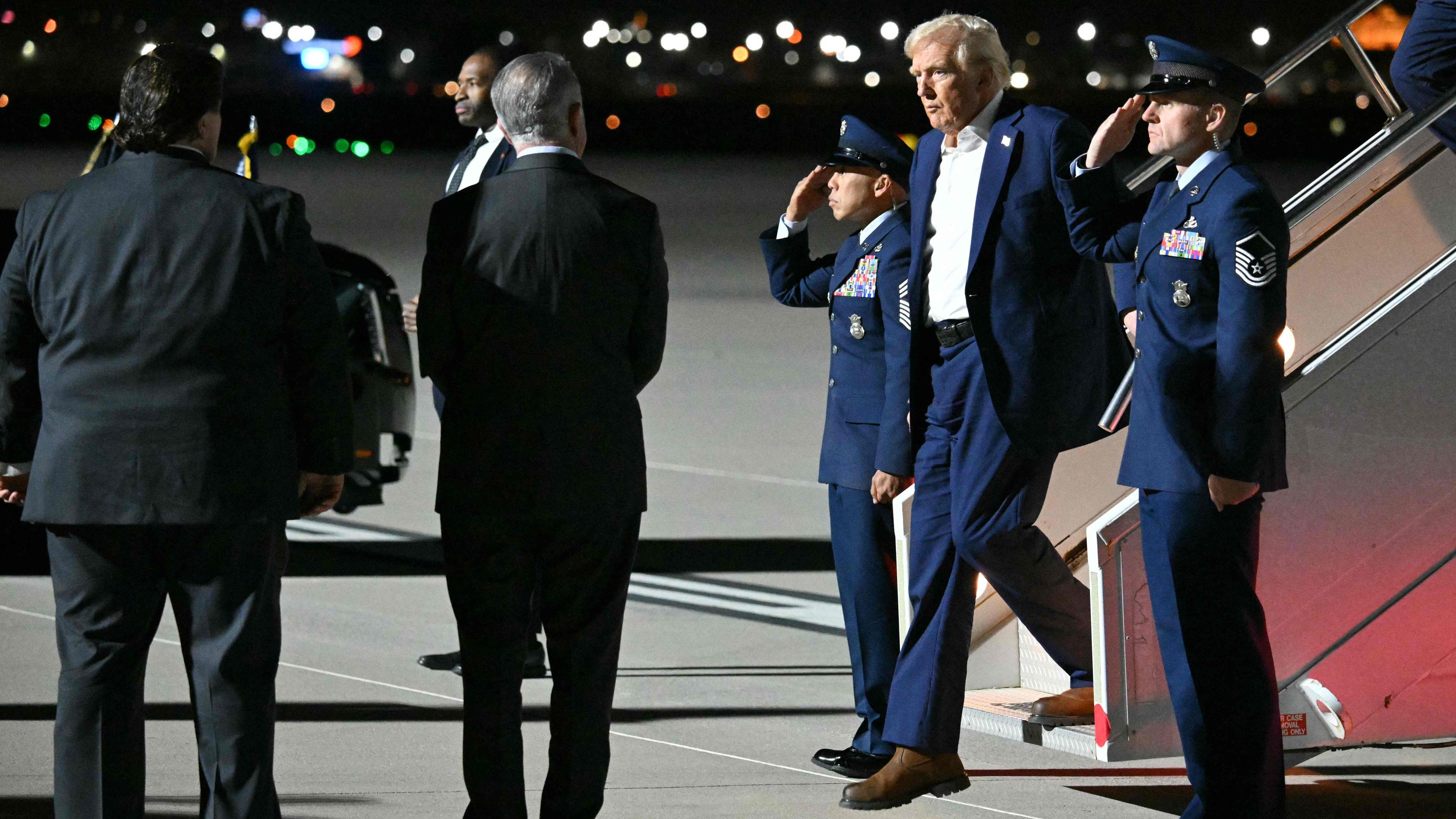 US President Donald Trump steps off Air Force One upon arrival at Harry Reid International Airport in Las Vegas.