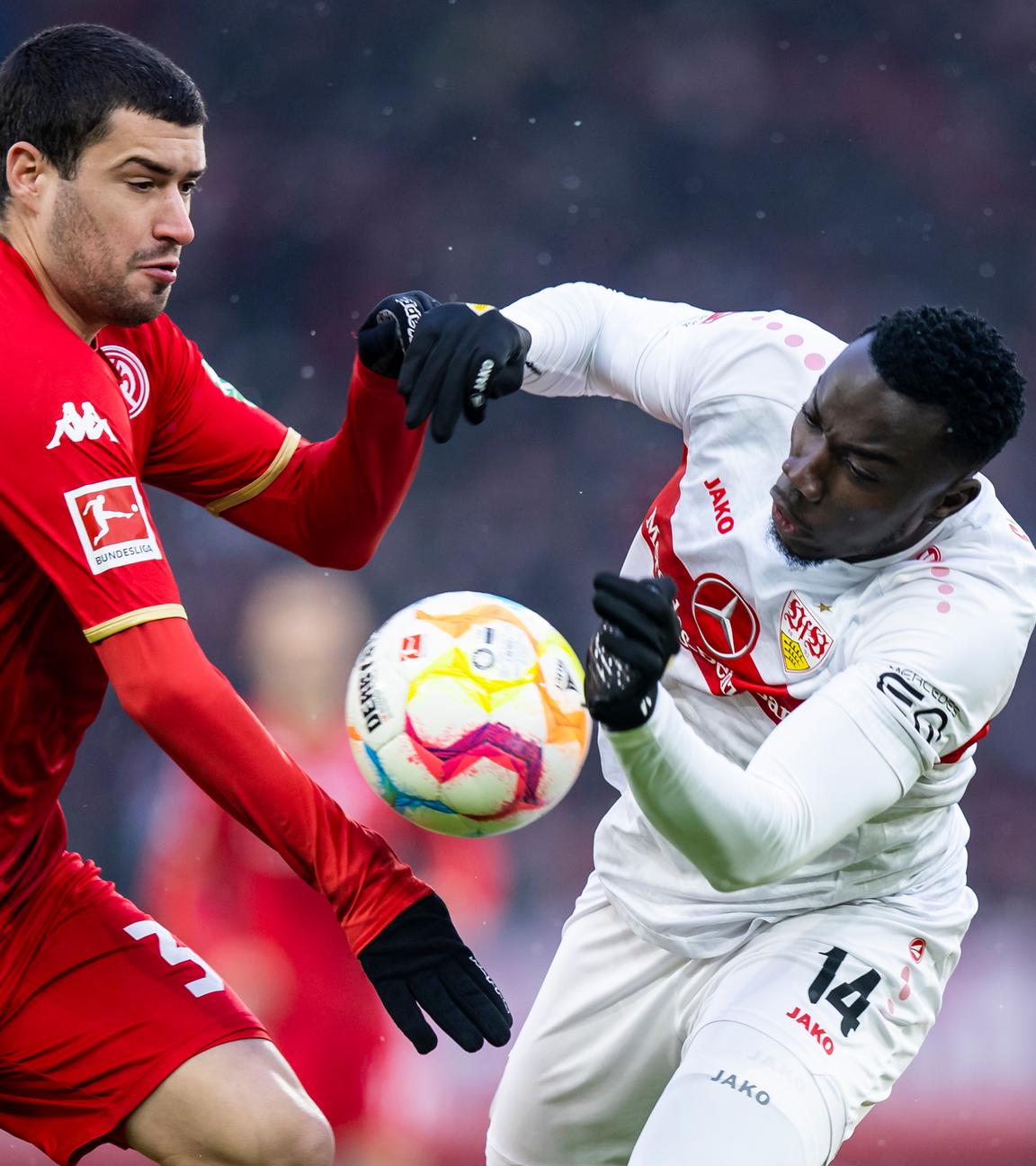 21.01.2023, Baden-Württemberg, Stuttgart: Fußball: Bundesliga, VfB Stuttgart - FSV Mainz 05, 16. Spieltag, Mercedes-Benz-Arena. Mainz 05 Aaron Martin (l) in Aktion gegen Stuttgarts Silas Katompa Mvumpa (r).