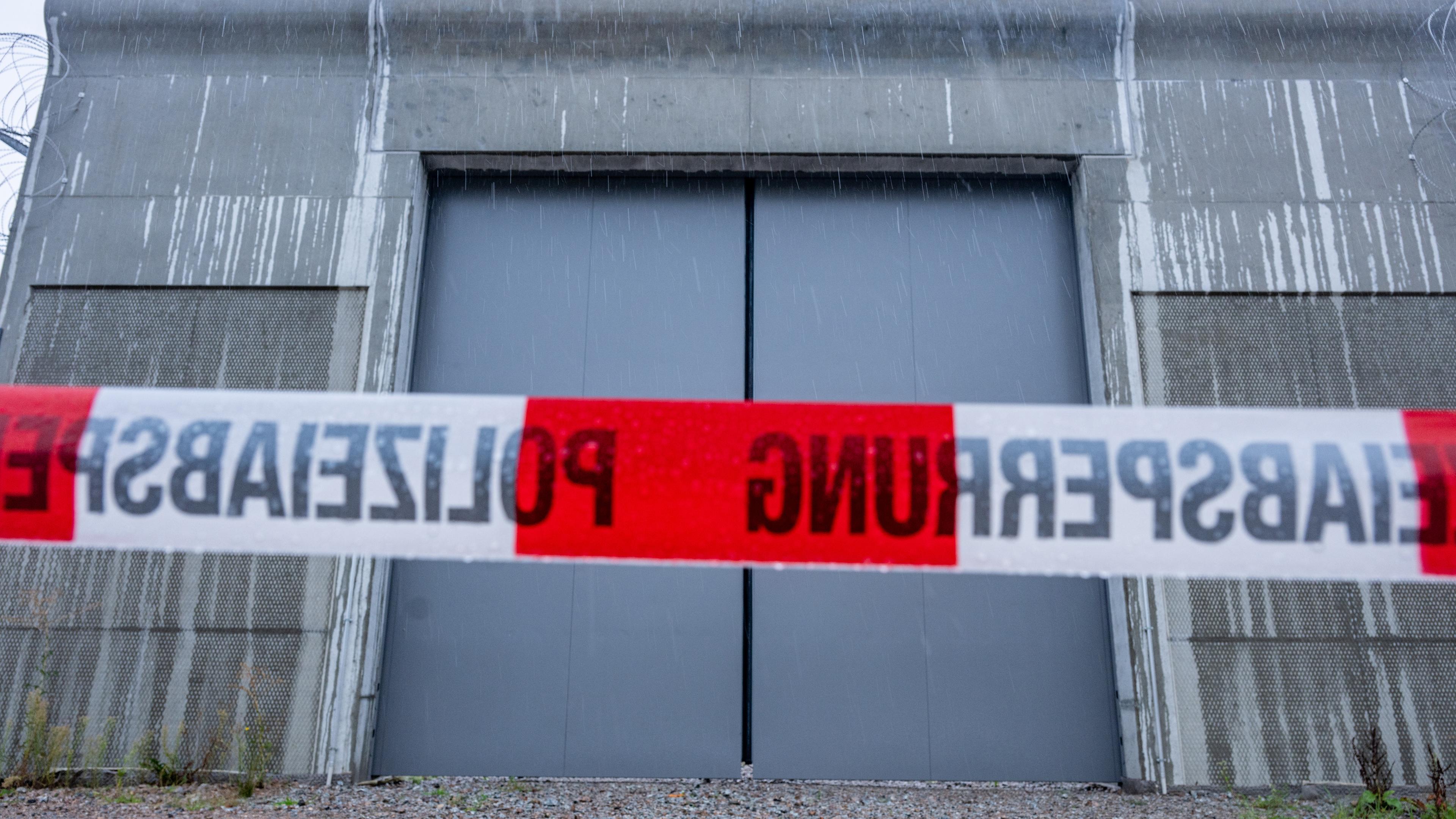 Ein Absperrband der Polizei ist vor einem Tor des Bezirkskrankenhauses Straubing angebracht.