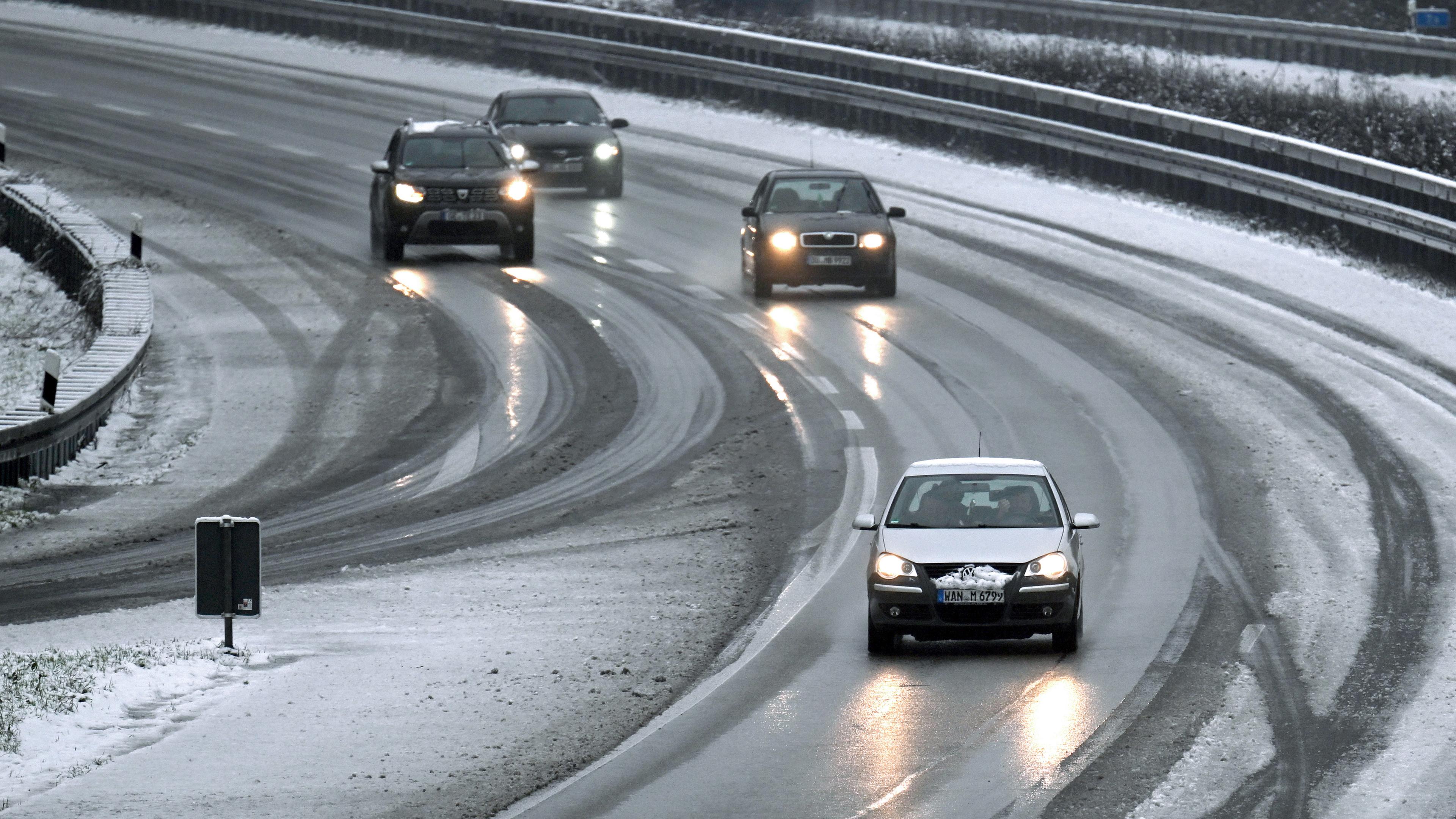 Nordrhein-Westfalen, Gelsenkirchen: Autos fahren auf der Autobahn 52 durch den Schneematsch. 